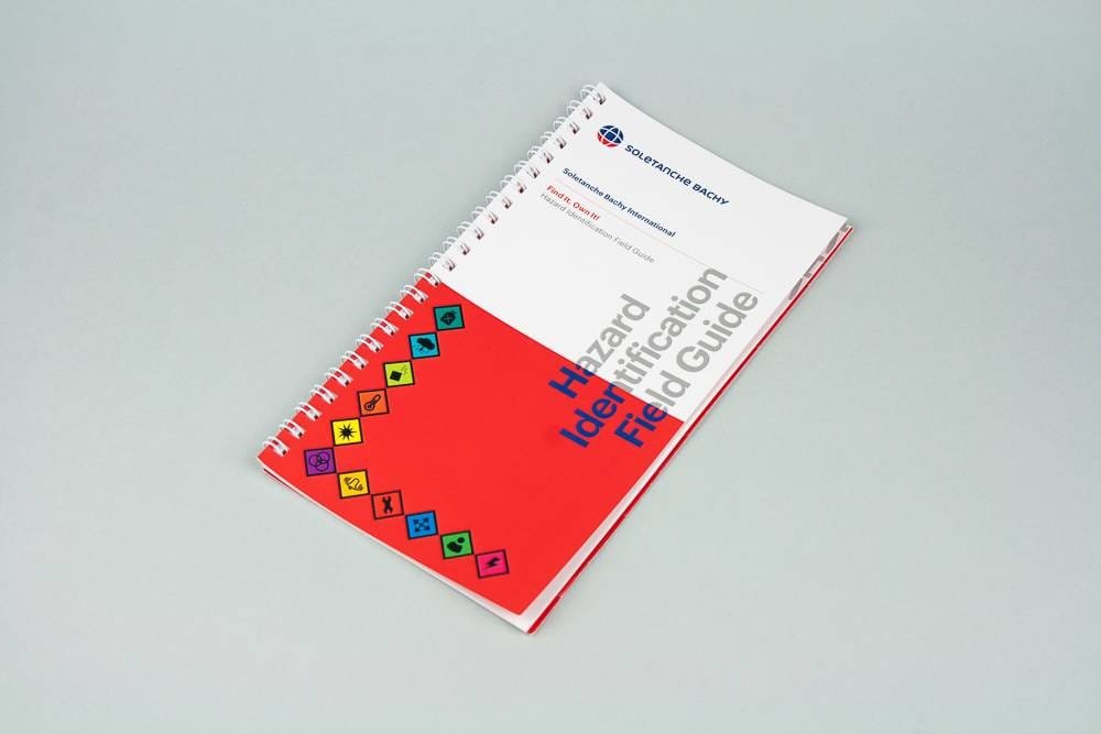Red safety guide, modern design by the Comhit agency, Paris, specialising in graphic design and visual communication.