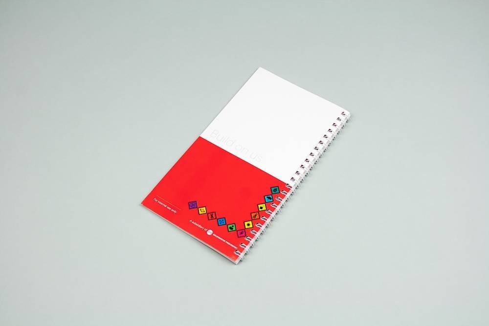 Notebook with minimalist graphic design in red and white, designed by the Comhit agency in Paris.