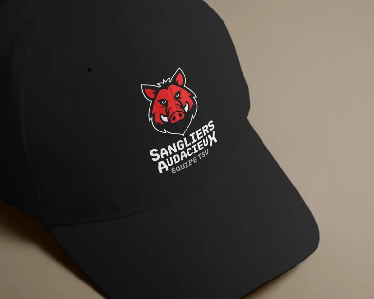 Black cap with red boar logo by Comhit, a branding agency in Paris, for the Sangliers Audacieux team.